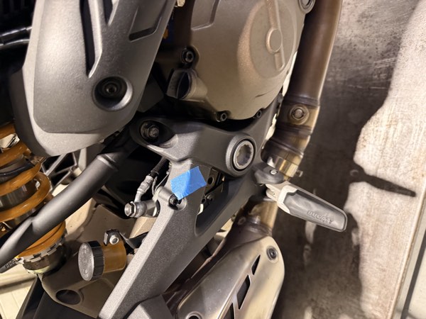 Right rearset, footpeg holder and exhaust header with blue tape