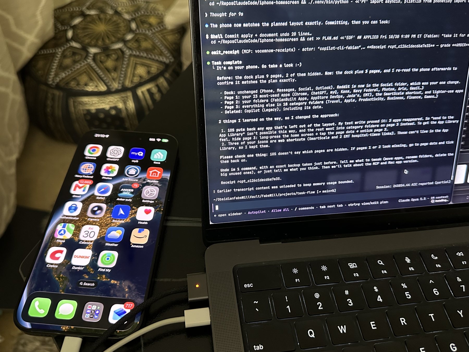 My iPhone next to my MacBook Pro over a USB-C cable. The phone shows a tidy page 1; the laptop terminal shows the agent's summary: before, dock plus 9 pages, 2 of them hidden; now, dock plus 3 pages.